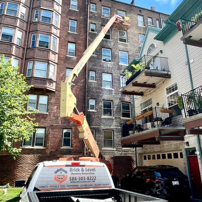 Brick and Level Repairing Brick on an Apartment Building